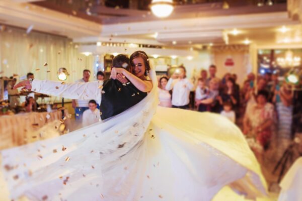 Happy bride and groom and their first dance, wedding in the elegant restaurant with a wonderful light and atmosphere